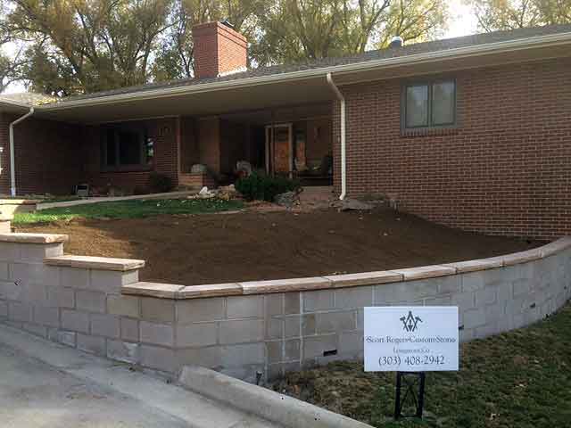 Cinder block retaining wall with Flagstone accents completed at this Berthoud home in 2018.