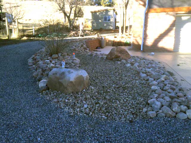 This riprap stone finished landscape in Lyons, CO, provides and excellent xeriscape along with functional stonework. 