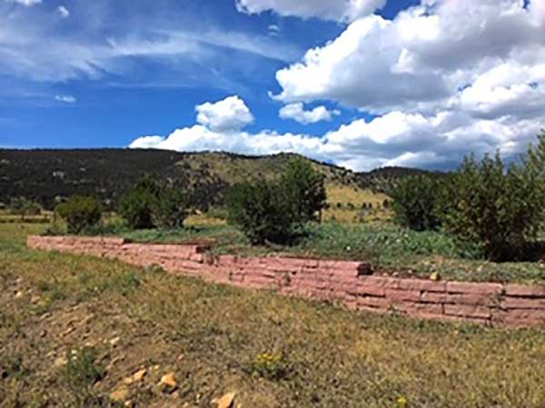 Colorado red strip stone walls ad flair to this rural home in Longmont, CO