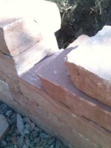 Colorado Red Strip Stone is a  dimensional stone perfect to construct landscaping walls with long stones that are fit together much like bricks.