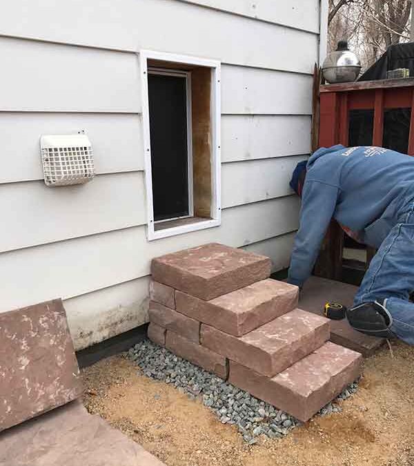 This custom dog entrance in Longmont, CO required an RS Custom Stone solution, which was a red flagstone dog staircase.