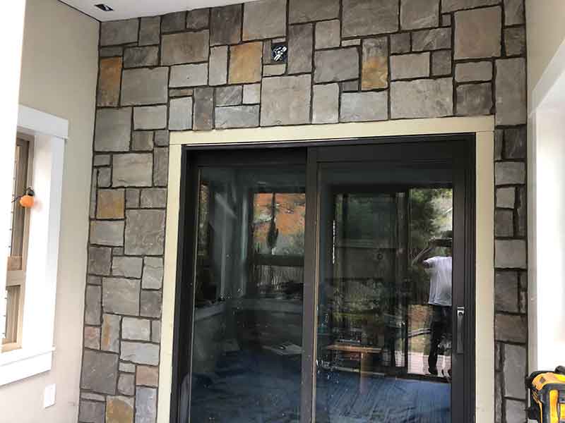 This blue and brown stone veneer makes a stunning accent to the back patio door of this Gunbarrel, CO, home.