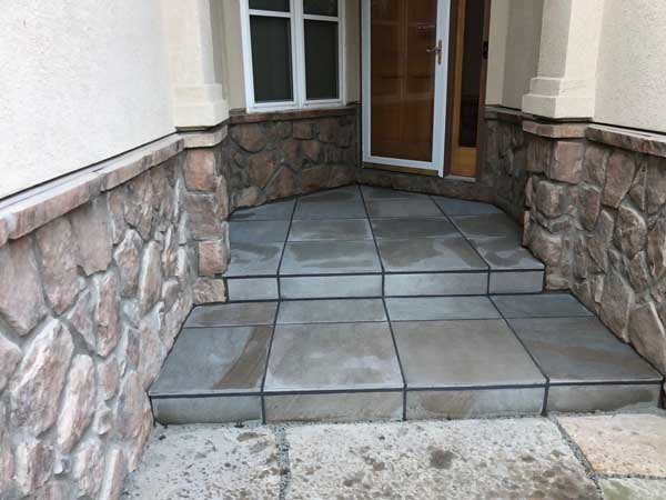 This front porch and steps was constructed in Erie, CO, during the winter of 2021/22, using what is fast becoming a favorite masonry product, blue porcelain pavers.