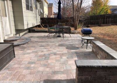The Bogert paver patio includes circular entry step and a bench made with matching Bogert products.