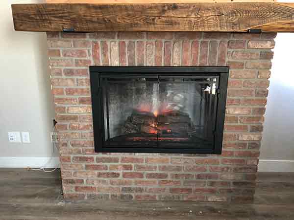 Brick fireplace with solid wood hearth in Longmont, CO, home