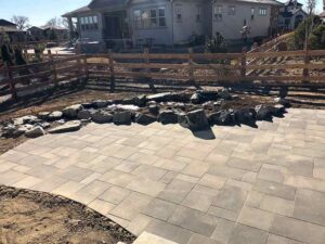 A stone enclosed garden compliments the stone paver patio in this Longmont home.