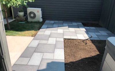 Porcelain all- and mixed-blue pavers create backyard patio and sidewalk in Prospect