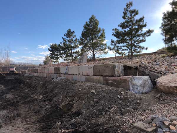 Giant concrete blocks create a very stable retaining wall at this rural Longmont property.